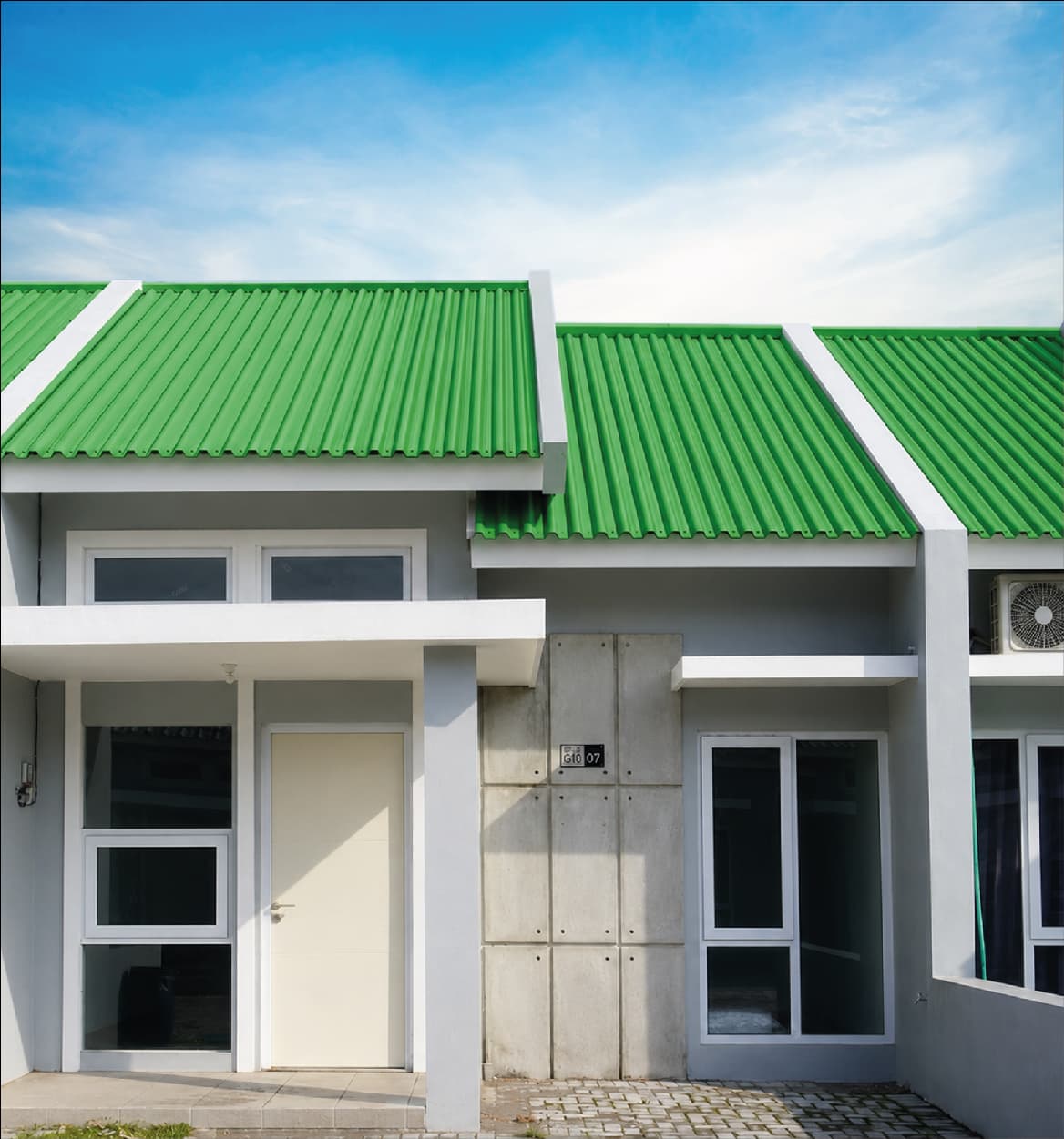 Row of houses roofed with bright green colour coated corrugated sheets